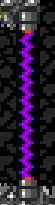 Vertical purple laser beam between rock walls